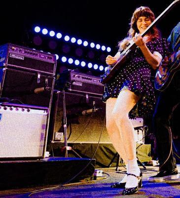 Jenny Lewis in fishnets, frilly white socks, and mary jane heels